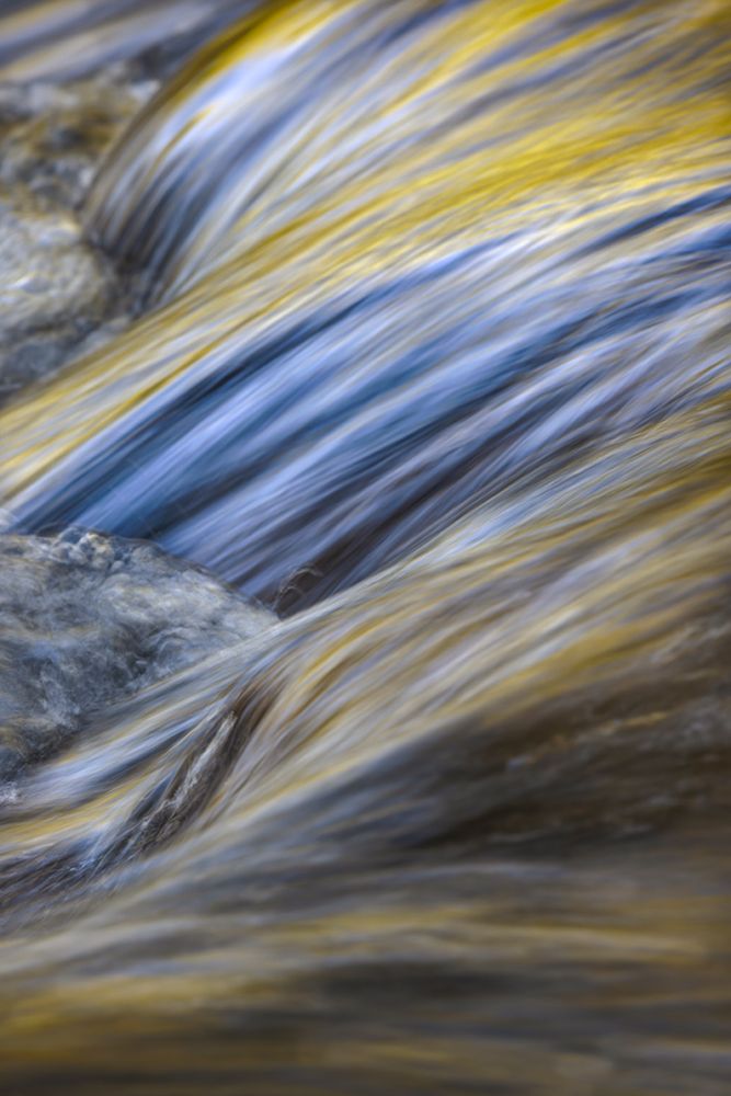 Spring foliage colors and sky reflecting on ripples on stream, Great Smoky Mountains NP, Tennessee
